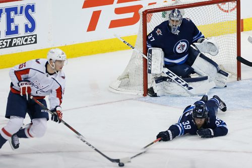 JOHN WOODS / WINNIPEG FREE PRESS
Winnipeg Jets' Toby Enstrom (39) goes down to block the pass by Washington Capitals' Andre Burakovsky (65) in front of goaltender Connor Hellebuyck (37) during first period NHL action in Winnipeg on Tuesday, February 13, 2018.