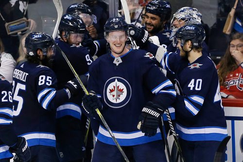 JOHN WOODS / WINNIPEG FREE PRESS
Tyler Myers (57) and the Winnipeg Jets celebrate his game winning goal against the Washington Capitals during overtime NHL action in Winnipeg on Tuesday, February 13, 2018.
