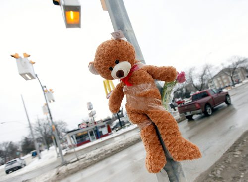 PHIL HOSSACK / WINNIPEG FREE PRESS - A teddy near hangs above the growing memorial cairn at the site of a young boy's death at Varennes ave and St Annes Rd Tuesday afternoon. See story. February 13, 2018