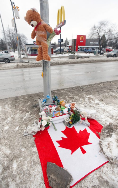 PHIL HOSSACK / WINNIPEG FREE PRESS - A teddy near hangs above the growing memorial cairn at the site of a young boy's death at Varennes ave and St Annes Rd Tuesday afternoon. See story. February 13, 2018