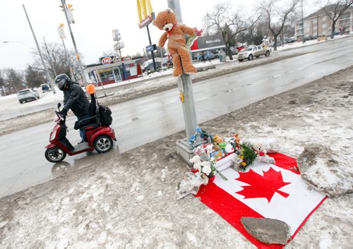 PHIL HOSSACK / WINNIPEG FREE PRESS - A teddy near hangs above the growing memorial cairn at the site of a young boy's death at Varennes ave and St Annes Rd Tuesday afternoon. See story. February 13, 2018