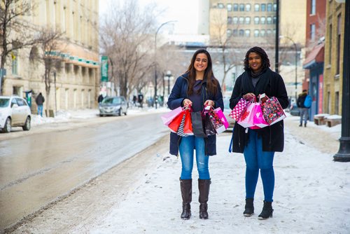 MIKAELA MACKENZIE / WINNIPEG FREE PRESS
Winnipeg project lead Imreet Kaur (left) and volunteer Faustine Muyenzi display packed gift bags for women's shelters as part of the One Billion Rising movement in Winnipeg, Manitoba on Wednesday, Feb. 14, 2018. 
180214 - Wednesday, February 14, 2018.