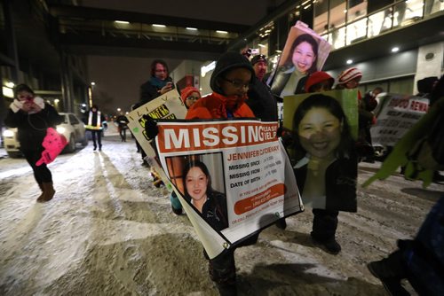 RUTH BONNEVILLE / WINNIPEG FREE PRESS


Family members hold signs and photos of Jennifer Catcheway who has been missing since 2008  with hundreds of other family members of missing and murdered Indigenous women, girls and two-spirits (MMIWG2S) during the 10th Annual Manitoba Memorial March for MMIWG2S Wednesday evening.  
Standup photo 
FEB 14, 2018