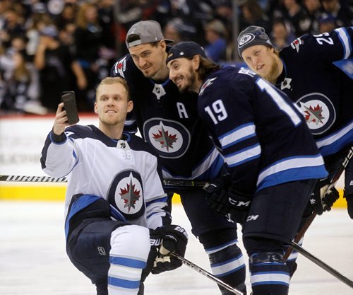 PHIL HOSSACK / WINNIPEG FREE PRESS - Nikolaj Ehlers takes a selfie with Mark Scheifele and Nic Petan Wedneday at Bell MTS Place Patrik Laine photobombs behind. The Jets showed off their skills for fans in the annual Skills Competition.  See story. February 13, 2018