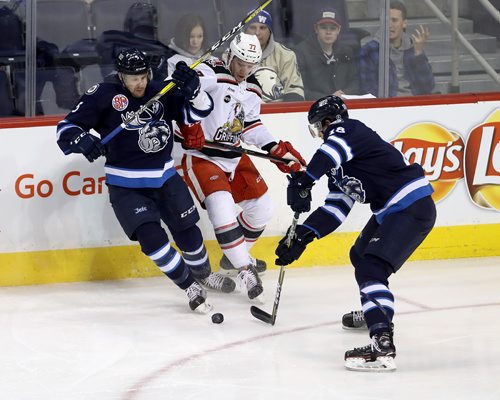 TREVOR HAGAN / WINNIPEG FREE PRESS
Manitoba Moose Cameron Schilling (5) ties up Grand Rapids Griffins Evgeny Svechnikov (77) so Brody Sutter (18) can get the puck, during the first period of AHL hockey action, Thursday, February 15, 2018.