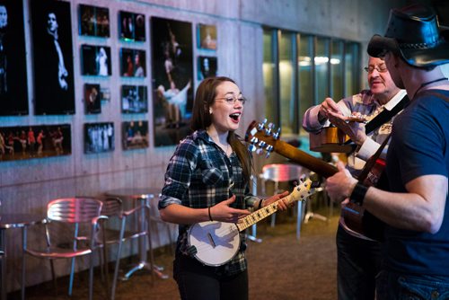MIKAELA MACKENZIE / WINNIPEG FREE PRESS
Zahra Larche, banjolele player, jams in the lobby before Once musical cast members lead guitarists, singers, and other musicians in a large group rendition of "Falling Slowly" at the Royal Manitoba Theatre Centre in Winnipeg, Manitoba on Friday, Feb. 16, 2018. 
180216 - Friday, February 16, 2018.