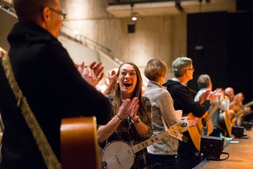 MIKAELA MACKENZIE / WINNIPEG FREE PRESS
Zahra Larche, banjolele player, applauds after Once musical cast members led guitarists, singers, and other musicians in a large group rendition of "Falling Slowly" at the Royal Manitoba Theatre Centre in Winnipeg, Manitoba on Friday, Feb. 16, 2018. 
180216 - Friday, February 16, 2018.