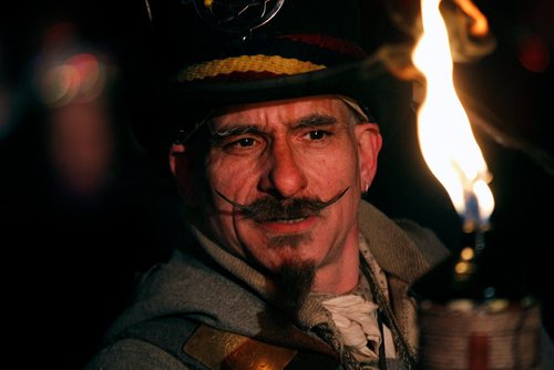 PHIL HOSSACK / Winnipeg Free Press - Festival du Voyageur Louis Gagne keeps an eye on his torch at Fort Gibralter Friday evening as the Festival opened it's 49th year. -  February 16, 2018