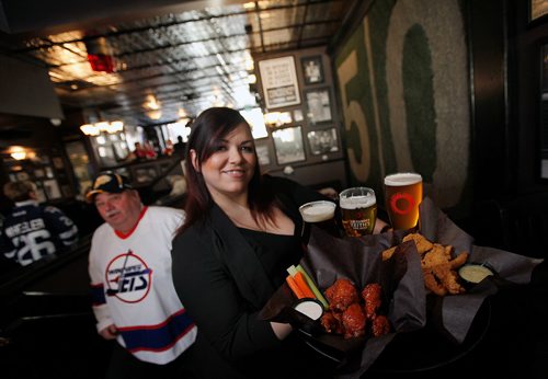 PHIL HOSSACK / Winnipeg Free Press - Meissa Ross shows off  Chicken Fingers and Honey Dill along with Wings at  "The Pint" underneath the 50 Yard line fromthe old stadium.. See Dave Sanderson's "Intersection" piece. -  February 16, 2018