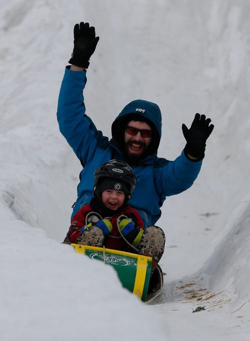 JOHN WOODS / WINNIPEG FREE PRESS
Jeremiah Lambert and son Xavier slide at the Festival du Voyageur in Winnipeg Sunday, February 18, 2017.