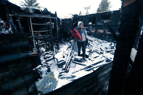 JOHN WOODS / WINNIPEG FREE PRESS
Holding one of his favourite props Al Simmons looks over the damage that resulted after a fire ripped through his prop trailers at his home in Anola Sunday, February 18, 2017.