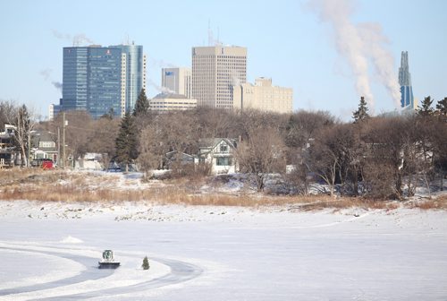 TREVOR HAGAN / WINNIPEG FRESS
A bobcat operator cleaning the river trail with downtown and the CMHR in the background, Monday, February 19, 2018.