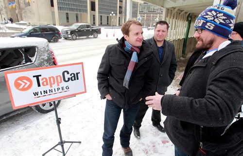 BORIS MINKEVICH / WINNIPEG FREE PRESS
TappCar made a major announcement today across from Winnipeg City Hall today. Pascal Ryffel, left, spoke to City councillor Matt Allard, right, at the event. They had a car there with the logo on it. Feb. 20, 2018