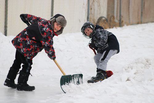 Canstar Community News Feb. 13, 2018 - Adysen Baird (left) and Matthew Kemerle (right) built an ince rink at Collicutt Schools backyard. (LIGIA BRAIDOTTI/CANSTAR/TIMES)