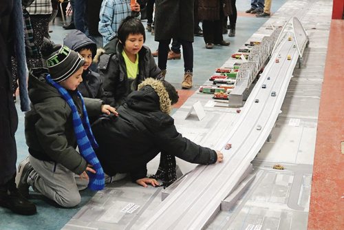 Canstar Community News Feb. 8, 2018 - Kids play at the seven-metre long scaled model of the new Arlington Bridge at the open house held at the North Centennial Recreation and Leisure Centre. (LIGIA BRAIDOTTI/CANSTAR/TIMES)