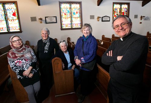 PHIL HOSSACK / WINNIPEG FREE PRESS - Left to right, Shahana Siddiqui, Margaret Steele, Margaret Wischnewski, Pat Stewart and Rev Murray Still pose at St James Anglican Church Wednesday,  Local Muslims and Anglicans are raising funds for a medical clinic in Uganda -- final fundraiser after 10 years of cooperation. See Brenda Suderman's story. - February 21, 2018