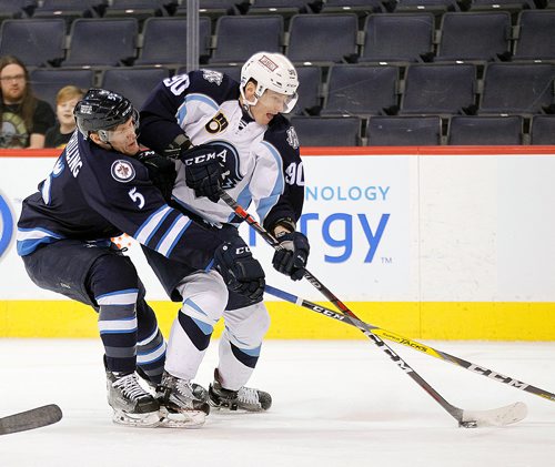 PHIL HOSSACK / WINNIPEG FREE PRESS - Manitoba Moose #5 Cameron Schilling ties up Milwaukee Admiral #90 inside the Moose end zone Wednesday evening at the Bell Mts Centre. - February 21, 2018