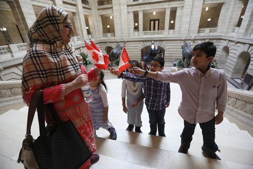 RUTH BONNEVILLE / WINNIPEG FREE 
PRESS 


Hummer Muhammad  hands out Canadian flags to kids while taking photos on the grand staircase just after the family became Canadian citizens at a ceremony at the Manitoba Legislative Thursday.

Names of 4 of her 5 kids in photo : Ayesha (7yrs), Mariam (8yrs), Saboor (8yrs glasses) and Absar (9yrs).  (not in photo is her youngest, Ali - 3yrs and her husband).  

Standup photo  



FEB 22, 2018