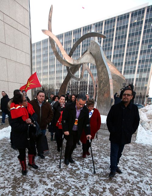 PHIL HOSSACK / WINNIPEG FREE PRESS -Derrick Henderson, Chief of Sagkeeng First Nation (on crutches) leads a procession of chiefs away from the Winnipeg Courthouse Thursday after Raymond Cormier was found not guilty in the murder of Tina Fontaine. See story.  - February 22, 2018