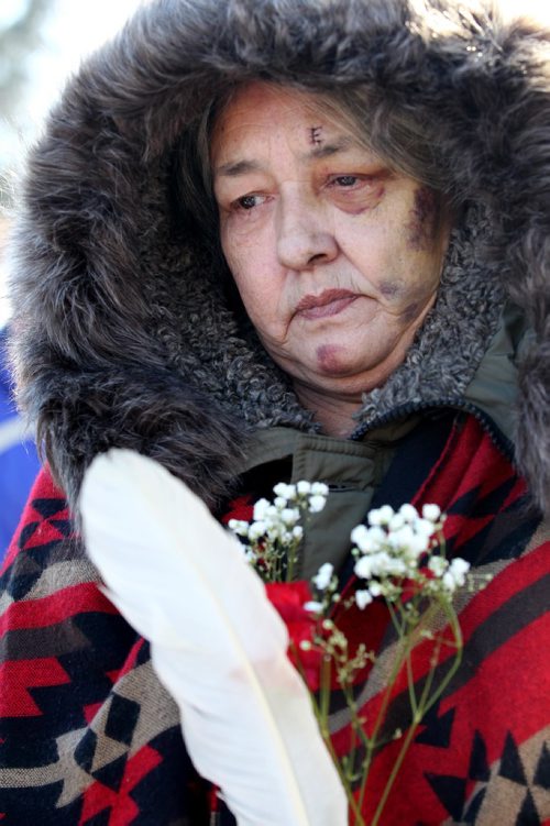 RUTH BONNEVILLE / WINNIPEG FREE PRESS

Thelma Favel, Tina Fontaine's great aunt, is overwhelmed with emotions  while holding a red carnation and eagle feather at the centre of the Oodena Circle with family during rally for Tina at the Forks Friday.  Hundreds of people march from the Law Courts to the the Forks holding signs  in support of Tina Fontaine's family members after a not guilty verdict was issued to Tina's accused killer, Raymond Cormier, Thursday.  

February 23, 2018