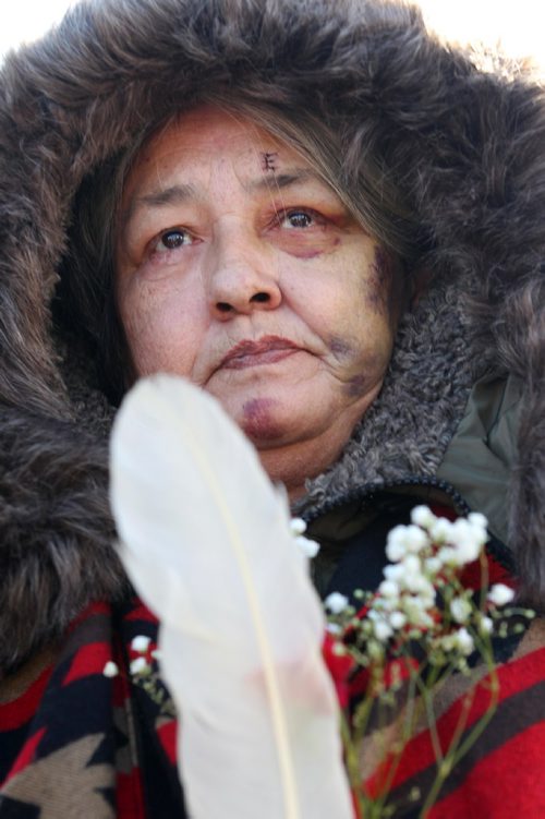 RUTH BONNEVILLE / WINNIPEG FREE PRESS

Thelma Favel, Tina Fontaine's great aunt, is overwhelmed with emotions  while holding a red carnation and eagle feather at the centre of the Oodena Circle with family during rally for Tina at the Forks Friday.  Hundreds of people march from the Law Courts to the the Forks holding signs  in support of Tina Fontaine's family members after a not guilty verdict was issued to Tina's accused killer, Raymond Cormier, Thursday.  

February 23, 2018
