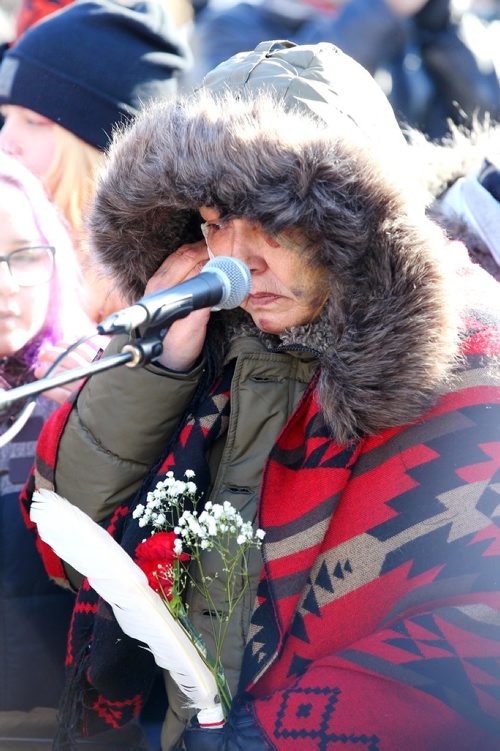 RUTH BONNEVILLE / WINNIPEG FREE PRESS

Thelma Favel, Tina Fontaine's great aunt, is overwhelmed with emotions  while holding a red carnation and eagle feather at the centre of the Oodena Circle with family during rally for Tina at the Forks Friday.  Hundreds of people march from the Law Courts to the the Forks holding signs  in support of Tina Fontaine's family members after a not guilty verdict was issued to Tina's accused killer, Raymond Cormier, Thursday.  

February 23, 2018