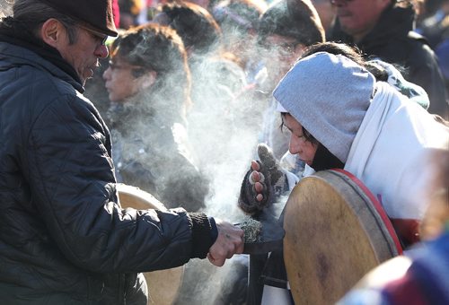 RUTH BONNEVILLE / WINNIPEG FREE PRESS

Elders offer smoke from sweet grass for people to smudge during rally in support of Tina Fontaine's famiily in Oodena Circle Friday. Hundreds of people march from the Law Courts to the the Forks holding signs  in support of Tina Fontaine's family members after a not guilty verdict was issued to Tina's accused killer, Raymond Cormier, Thursday.  

February 23, 2018

