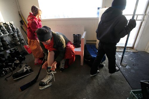PHIL HOSSACK / WINNIPEG FREE PRESS - Doris Wurtz Laces up before heading onto the Baker Community Ice for a scrimmage with other women and some of the community's children. See Melissa Martin's story. February 23, 2018