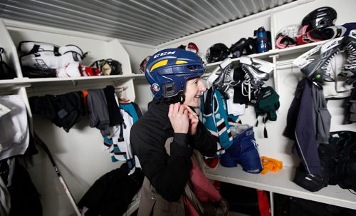 PHIL HOSSACK / WINNIPEG FREE PRESS - Judith Maendel fits her helmet at the Baker Colony change hut before heading to MacGregor for the annual charity hockey game. See Melissa Martin's story. February 23, 2018