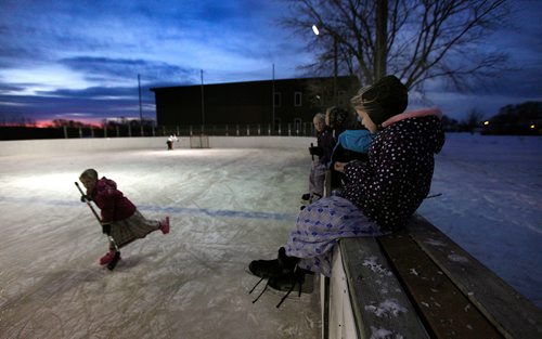 PHIL HOSSACK / WINNIPEG FREE PRESS - Women and children at the Baker Community gather on the ice after school. -See Melissa Martin's story.  - February 23, 2018