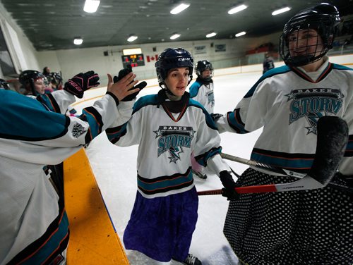 PHIL HOSSACK / WINNIPEG FREE PRESS - Judith Maendel takes a reluctant "hi-5" after she and her line score against their opponents the Iron Maidens at the MacGregor arena. See Melissa Martin's story. February 23, 2018