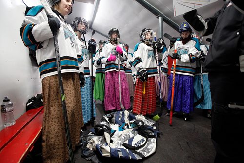 PHIL HOSSACK / WINNIPEG FREE PRESS - Members of the Hutterite "Baker Storm" listen to a little guidance between periods at the MacGregor annual charity game. See Melissa Martin's story. February 23, 2018