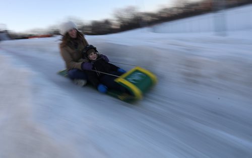 TREVOR HAGAN / WINNIPEG FREE PRESS
Nickeeya Lecocq, and her son, Takoda, 4, tobogganing at the Festival du Voyageur, Friday, February 23, 2018.