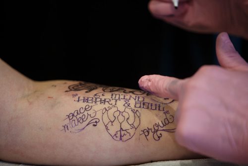 MIKE DEAL / WINNIPEG FREE PRESS
Kristan Bremner gets a tattoo by Jamie Watson during The Winnipeg Tattoo Show at the convention centre Saturday.
180224 - Saturday, February 24, 2018.