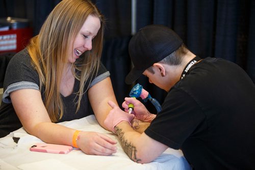 MIKE DEAL / WINNIPEG FREE PRESS
Kristan Bremner gets a tattoo by Jamie Watson during The Winnipeg Tattoo Show at the convention centre Saturday.
180224 - Saturday, February 24, 2018.