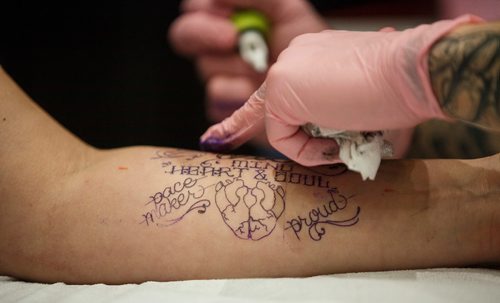 MIKE DEAL / WINNIPEG FREE PRESS
Kristan Bremner gets a tattoo by Jamie Watson during The Winnipeg Tattoo Show at the convention centre Saturday.
180224 - Saturday, February 24, 2018.