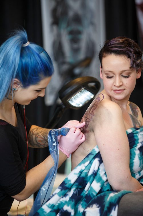 MIKE DEAL / WINNIPEG FREE PRESS
Nicole Roy gets a tattoo by Kalei Jaworski during The Winnipeg Tattoo Show at the convention centre Saturday.
180224 - Saturday, February 24, 2018.