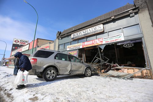 TREVOR HAGAN / WINNIPEG FRESS
A two vehicle collision at the corner of Portage Avenue and Arlington Street sent one vehicle crashing into the front of Body Shades Tanning, Sunday, February 25, 2018.