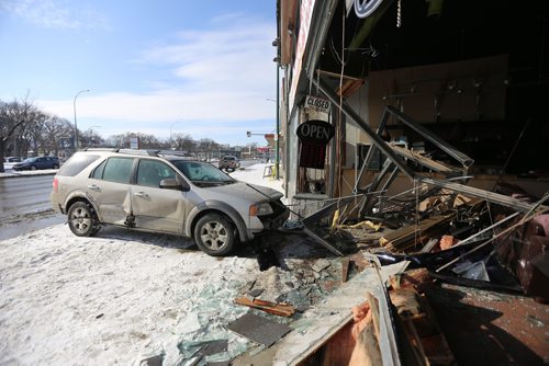 TREVOR HAGAN / WINNIPEG FRESS
A two vehicle collision at the corner of Portage Avenue and Arlington Street sent one vehicle crashing into the front of Body Shades Tanning, Sunday, February 25, 2018.