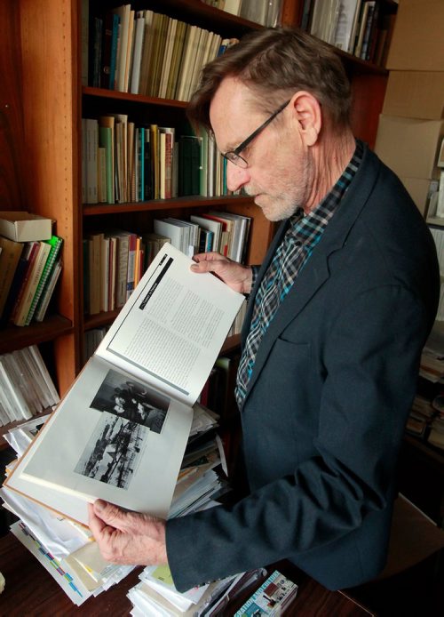 BORIS MINKEVICH / WINNIPEG FREE PRESS
Royden Loewen Chair in Mennonite Studies University of Winnipeg poses for a photo in his office. Here he looks at a book done on the Ukranian Mennonites. A fellowship has been struck to access the recently opened KGB archives in Ukraine. The fellowship will be researching records of the more than 30,000 Mennonites who went missing during the Stalin's reign of terror. BILL REDEKOP STORY. Feb. 26, 2018