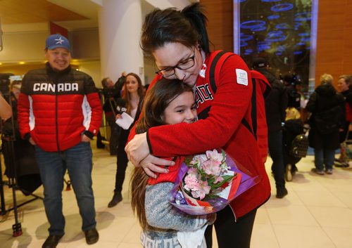 JOHN WOODS / WINNIPEG FREE PRESS
As her father Terrence looks on Brigette Lacquette of Mallard, silver in hockey, gets hugs and flowers from Hayden Halcrow as she arrives home from the winter olympics Monday, February 26, 2018.