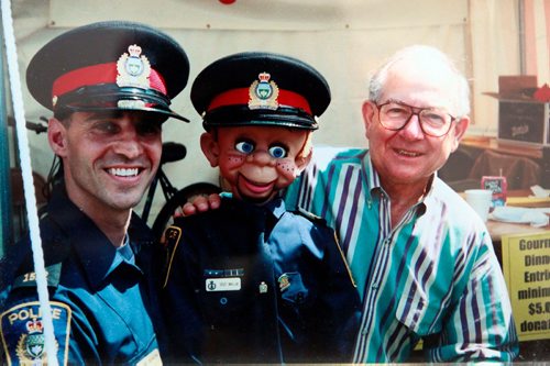BORIS MINKEVICH / WINNIPEG FREE PRESS
Police officer Dave Dixon and his dummy Sgt. Willie are retiring this week. Dixon and his dummy ran public education programs in public schools in the early 2000s. Hes retiring and the dummy is going into the Wpg Police Museum on Friday. This is a treasured photo of Dixon meeting "Mr. Dressup" Ernie Coombs. BILL REDEKOP STORY. Feb. 27, 2018
