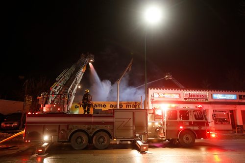 JOHN WOODS / WINNIPEG FREE PRESS
Firefighters work on a fire at a used car dealer at 951 Portage Avenue Tuesday, February 27, 2018.