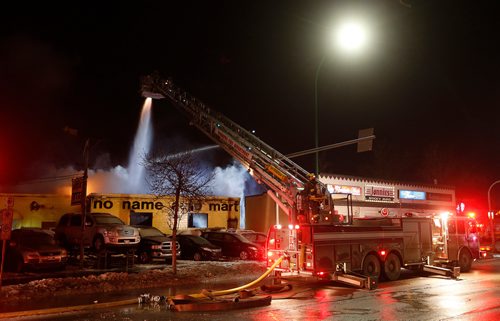 JOHN WOODS / WINNIPEG FREE PRESS
Firefighters work on a fire at a used car dealer at 951 Portage Avenue Tuesday, February 27, 2018.