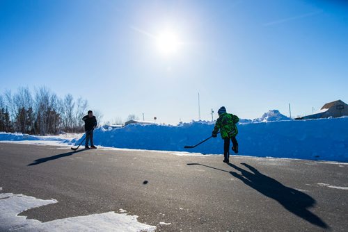 MIKAELA MACKENZIE / WINNIPEG FREE PRESS
Christian Bourassa (left), 10, and Journey Sinclair, 7, play street hockey on the Chemawawin Reserve, Manitoba on Friday, Feb. 23, 2018. 
180223 - Friday, February 23, 2018.