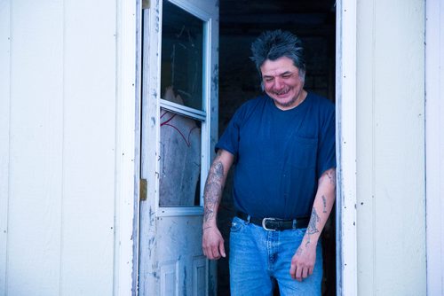 MIKAELA MACKENZIE / WINNIPEG FREE PRESS
Dog owner Douglas Lachose, chats on his porch on the Chemawawin Reserve, Manitoba on Friday, Feb. 23, 2018. 
180223 - Friday, February 23, 2018.