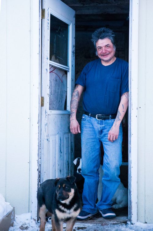 MIKAELA MACKENZIE / WINNIPEG FREE PRESS
Douglas Lachose and his dog, Akira, pose on his porch on the Chemawawin Reserve, Manitoba on Friday, Feb. 23, 2018. 
180223 - Friday, February 23, 2018.