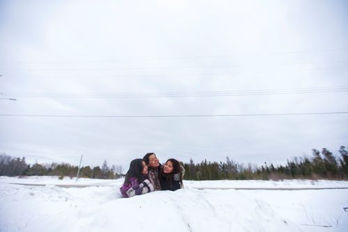 MIKAELA MACKENZIE / WINNIPEG FREE PRESS
Mercedes Thomas, 8, (left) Sunshine Sinclair, 11, and Destiny Captain, 11, play in the snow on the Chemawawin First Nation Reserve, Manitoba on Saturday, Feb. 24, 2018. 
180224 - Saturday, February 24, 2018.