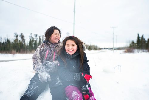 MIKAELA MACKENZIE / WINNIPEG FREE PRESS
Sunshine Sinclair (left), 11, and Destiny Captain, 11, play in the snow on the Chemawawin First Nation Reserve, Manitoba on Saturday, Feb. 24, 2018.
180224 - Saturday, February 24, 2018.