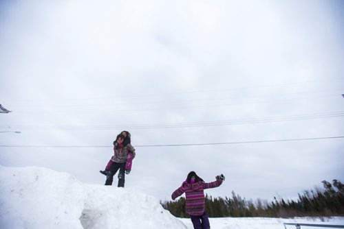 MIKAELA MACKENZIE / WINNIPEG FREE PRESS
Sunshine Sinclair, 11, Destiny Captain, 11, and Mercedes Thomas, 8, play in the snow on the Chemawawin First Nation Reserve, Manitoba on Saturday, Feb. 24, 2018. 
180224 - Saturday, February 24, 2018.